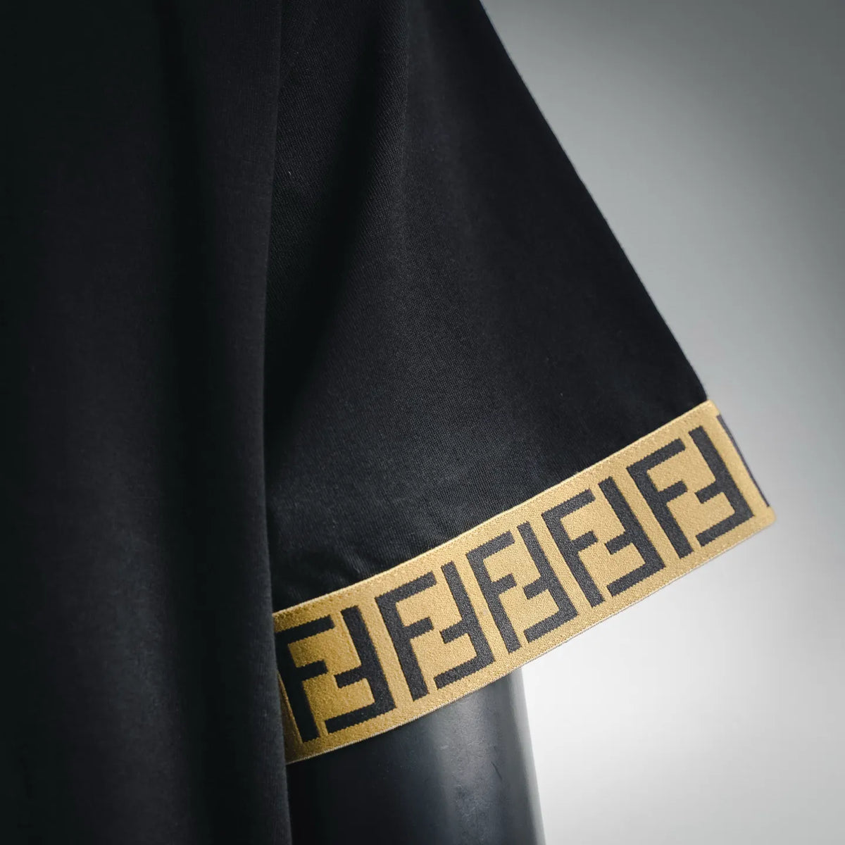 Black T-shirt with gold F logo jacquard band on sleeve cuff