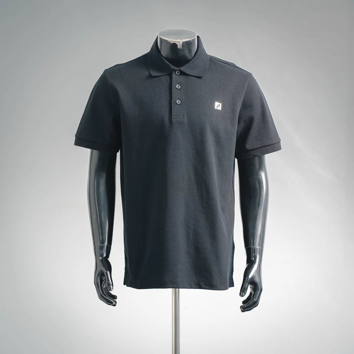 Fendi dark polo shirt with short sleeves, buttoned collar, chest F logo.