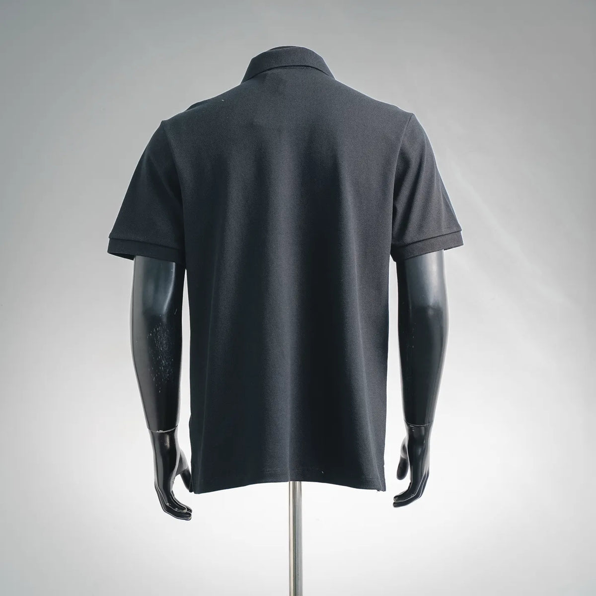 Fendi dark polo shirt back view with short sleeves and plain hem.