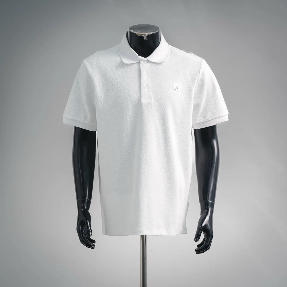 Fendi short-sleeve polo shirt in white, with button placket and small logo on chest.