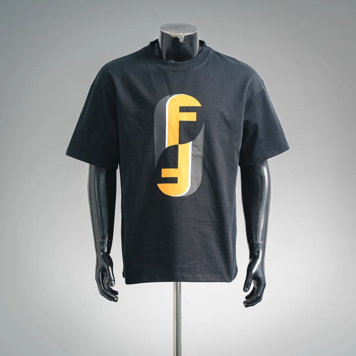 Black crew-neck T-shirt with yellow Fendi logo graphic on chest