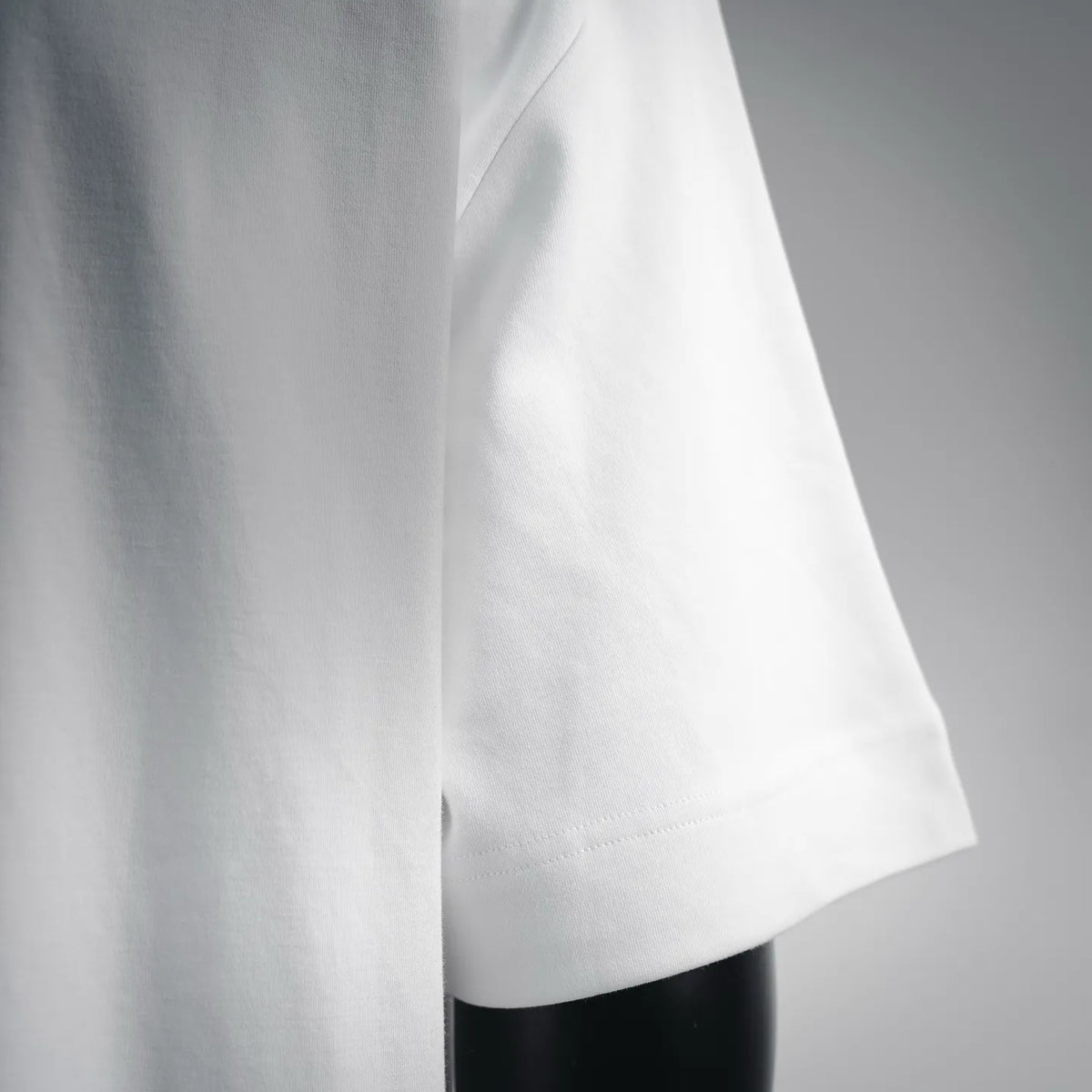 White Fendi T-shirt sleeve and hem stitching, side view