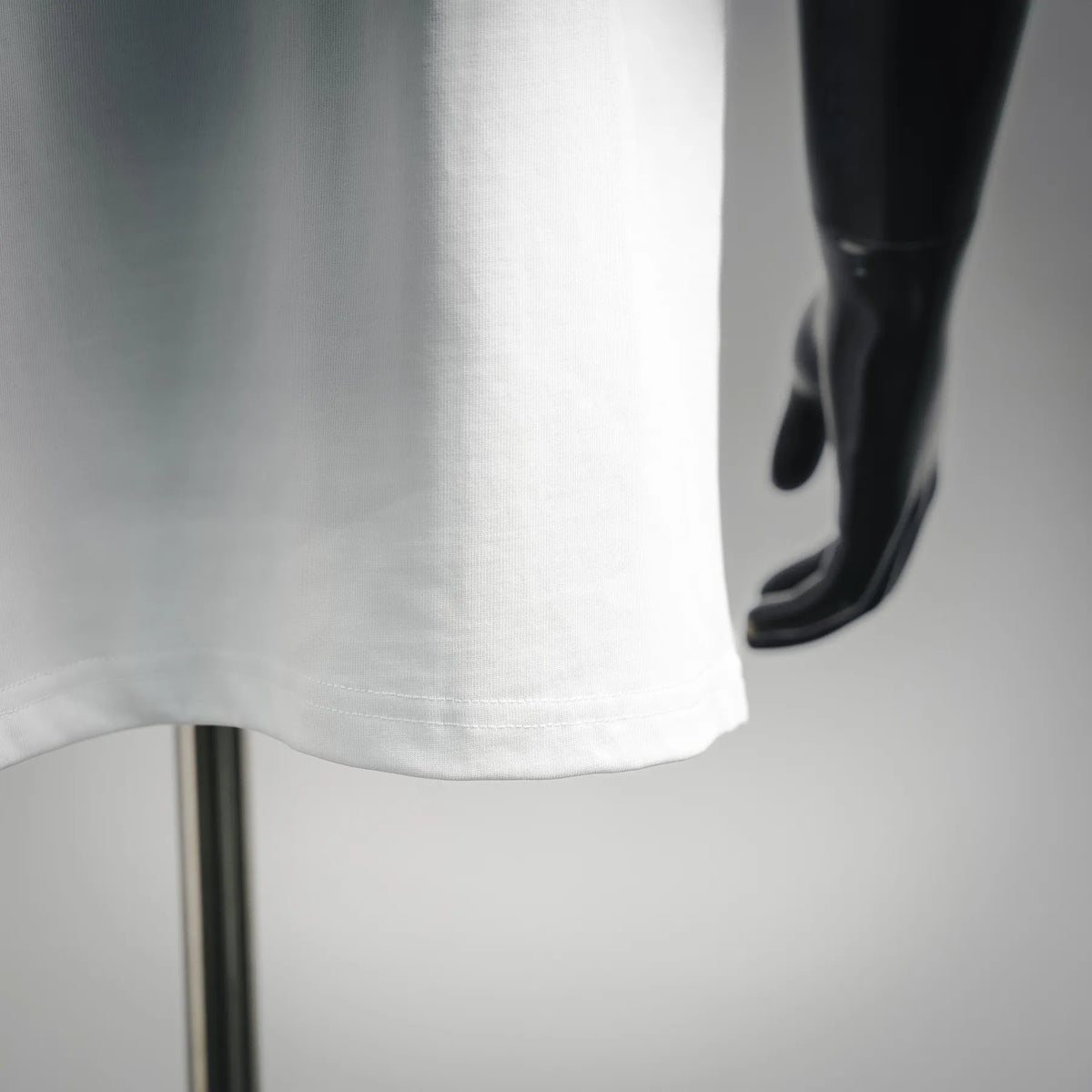 White T-shirt hem with visible side seam stitching