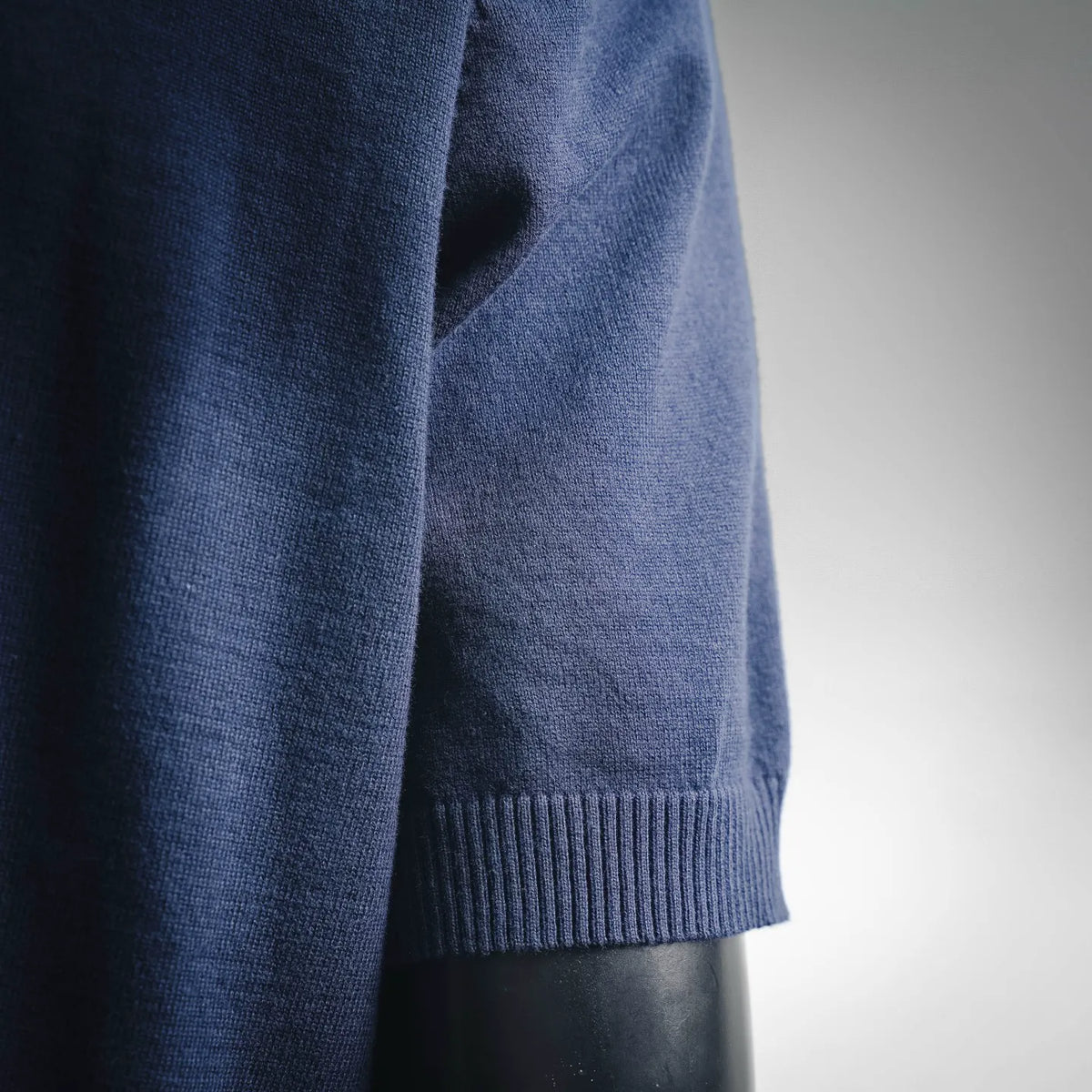 Navy knit short-sleeve sweater with ribbed sleeve cuff detail