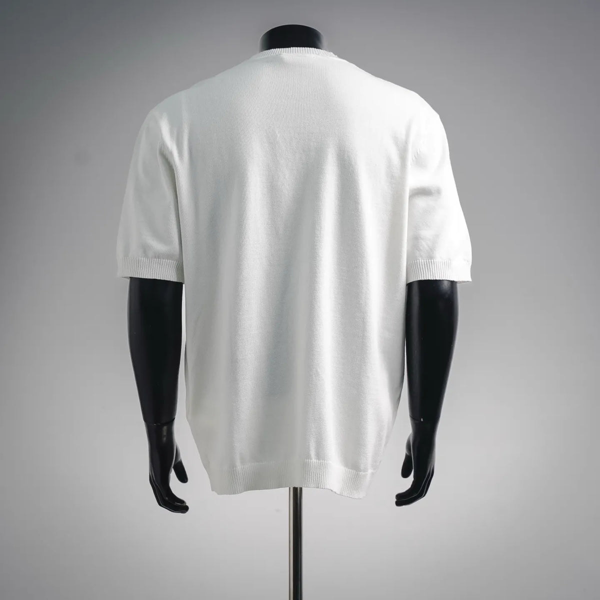 White short-sleeve knit top, ribbed crew neck and cuffs, back view