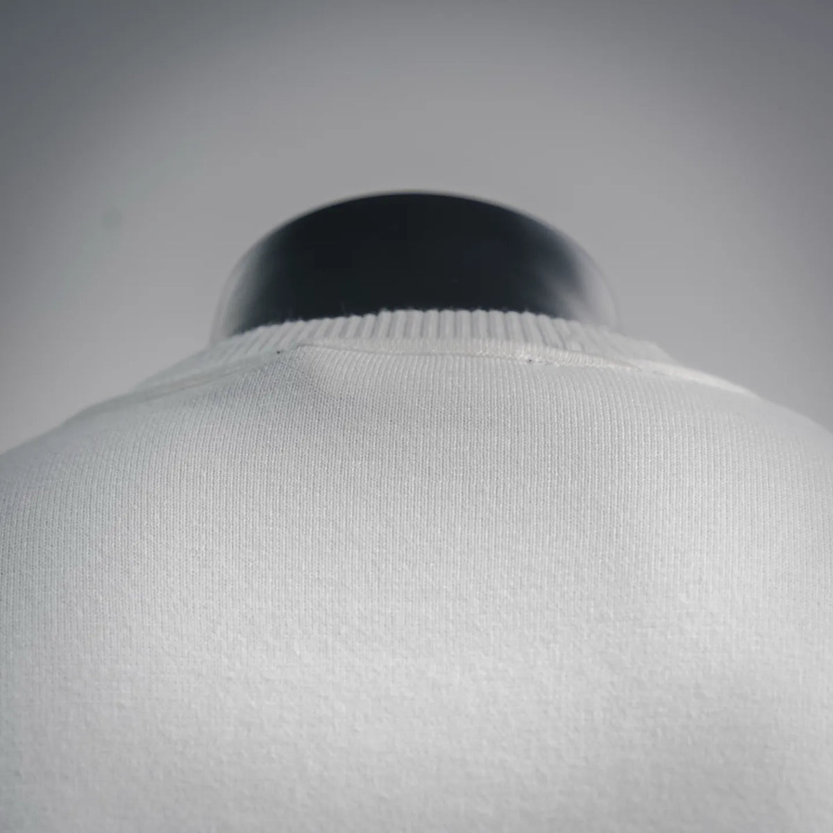 White crew-neck sweater collar, ribbed knit finish