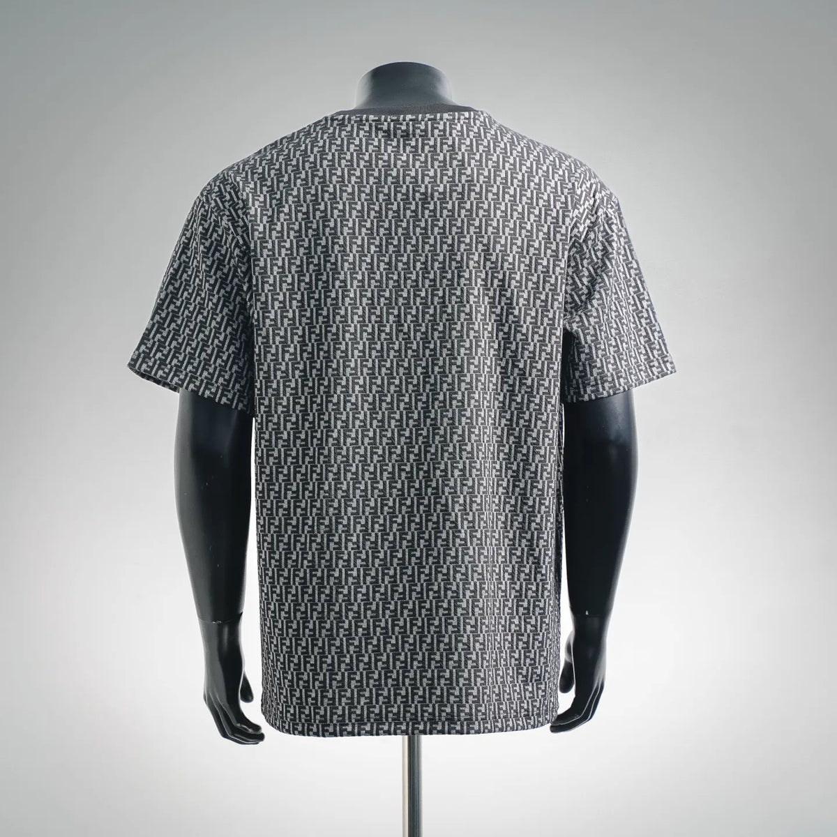 Back view of short-sleeve knit top with repeating FF pattern in dark and light gray.