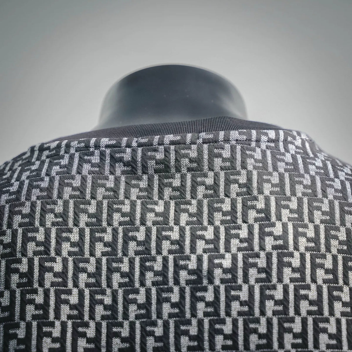 Ribbed crewneck and FF pattern knit in dark and light gray on short-sleeve top.