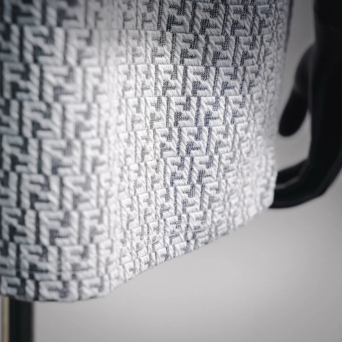 Close-up of white knit T-shirt with dark Fendi monogram pattern