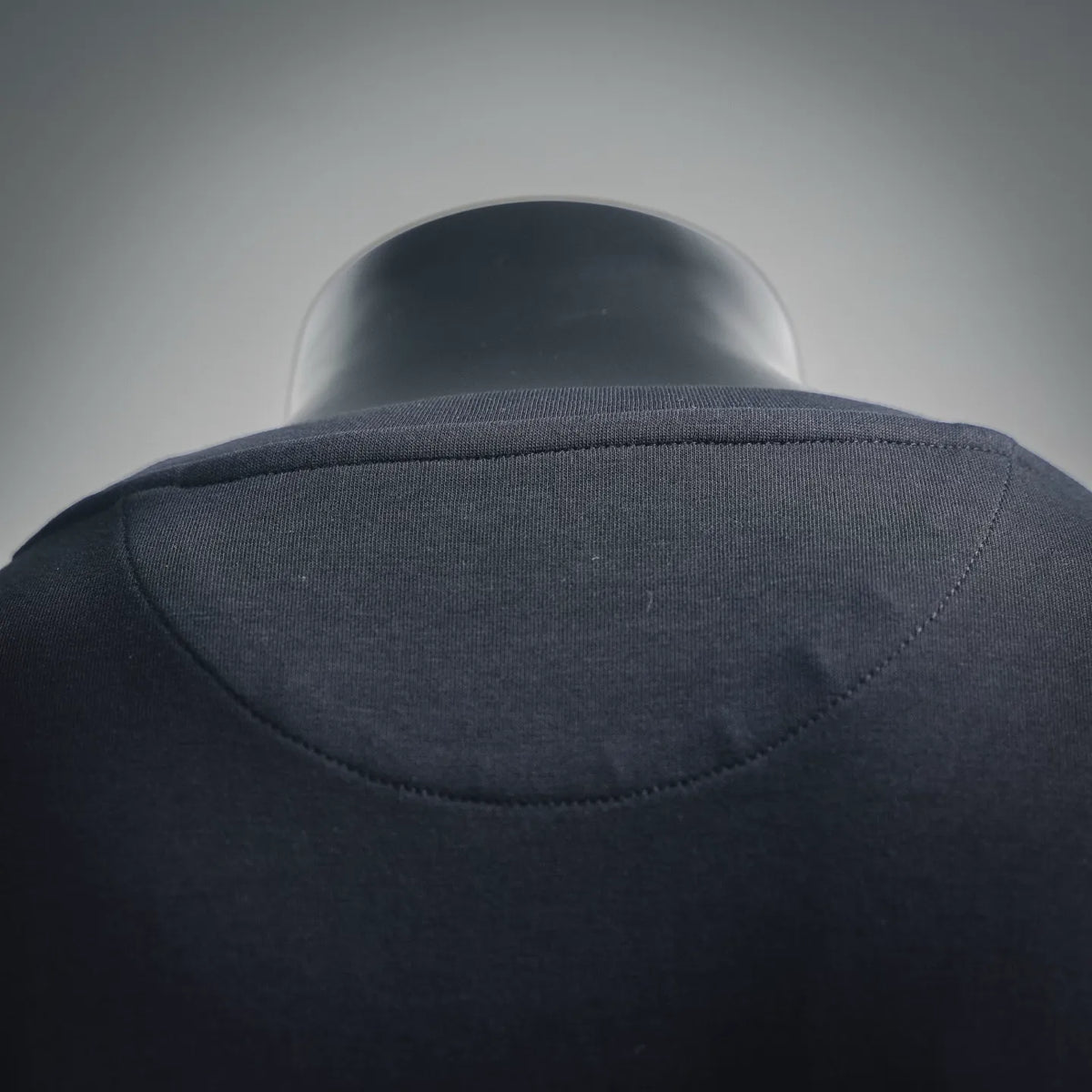 Black crew-neck T-shirt collar back with curved seam detail