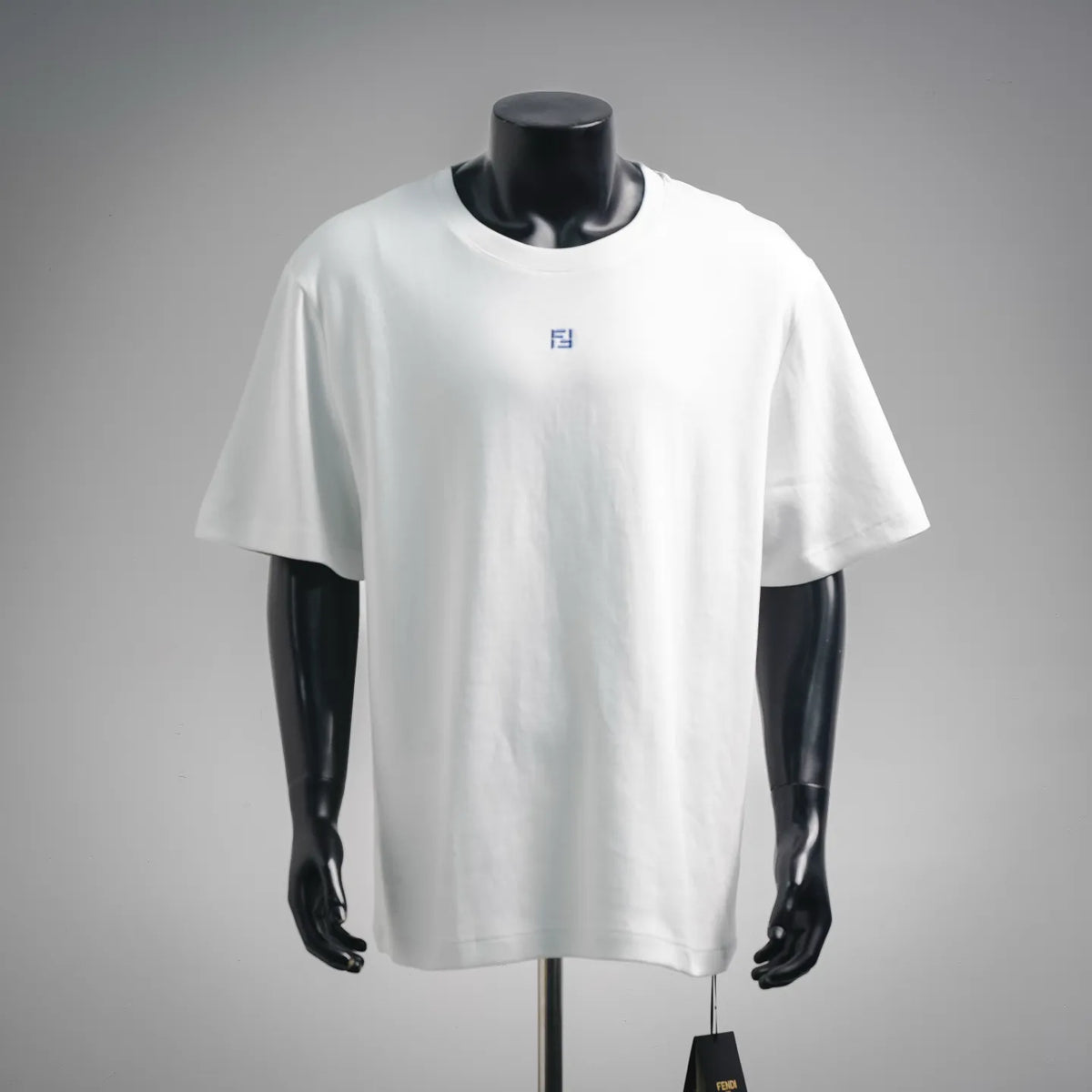 White crewneck T-shirt with small blue Fendi-style logo on the chest