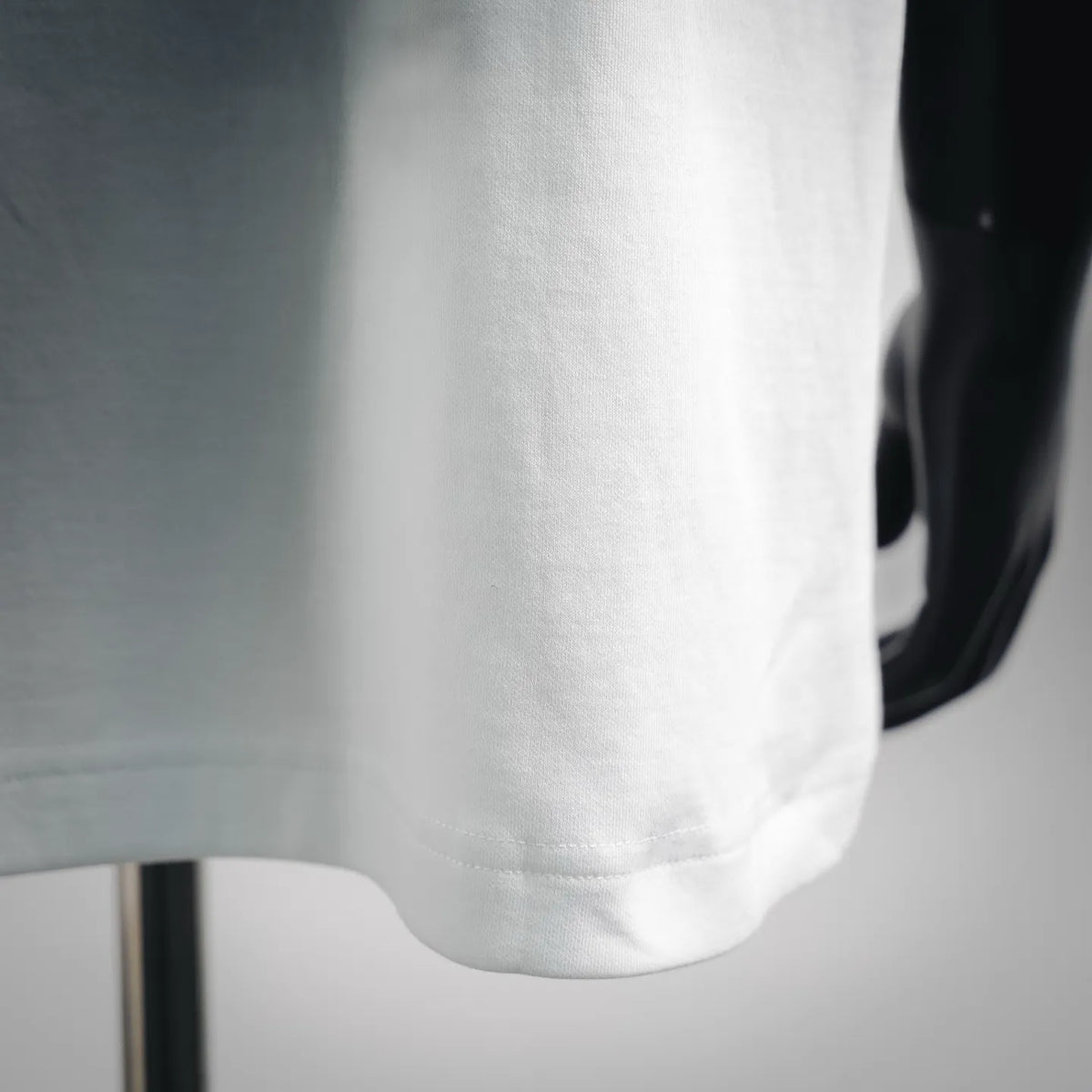 White T-shirt front hem with visible stitching