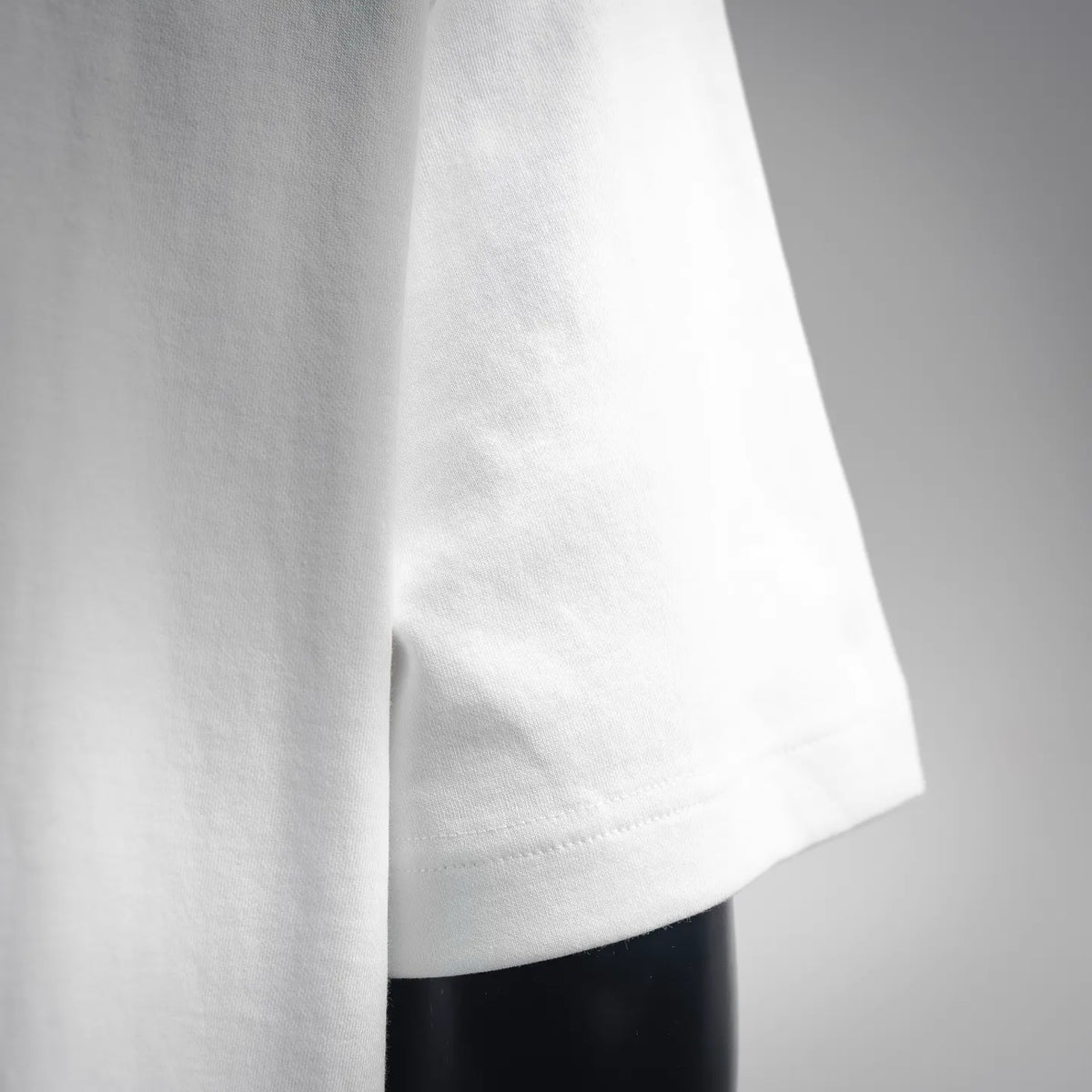 White T-shirt side view with sleeve hem stitching