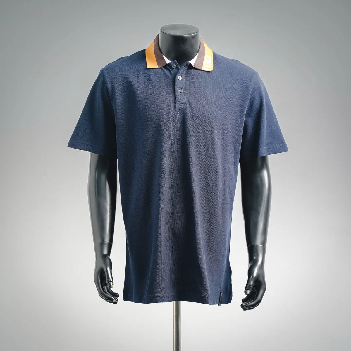 Navy Fendi polo shirt on a mannequin with button placket and yellow striped collar