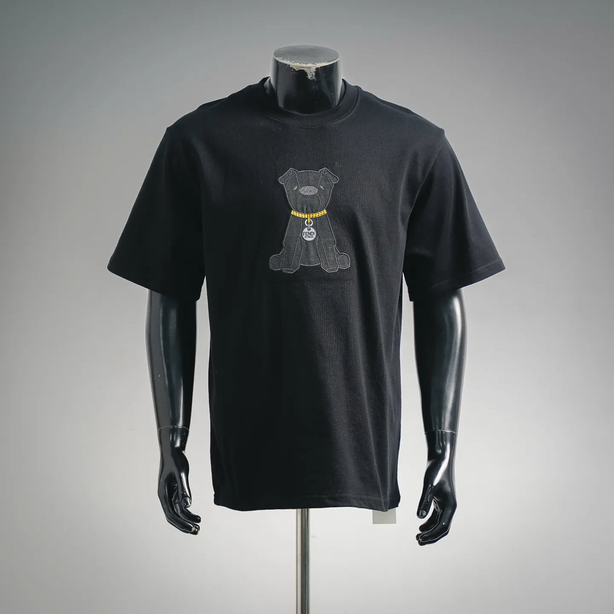 Black short-sleeve T-shirt with embroidered dog graphic and yellow collar detail