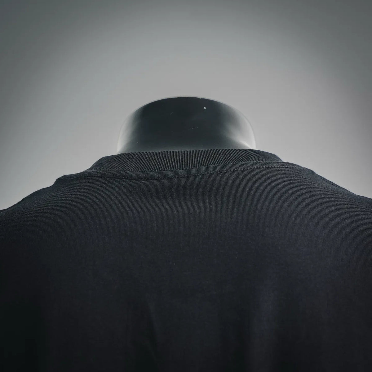 Black T-shirt neck ribbing and shoulder seam