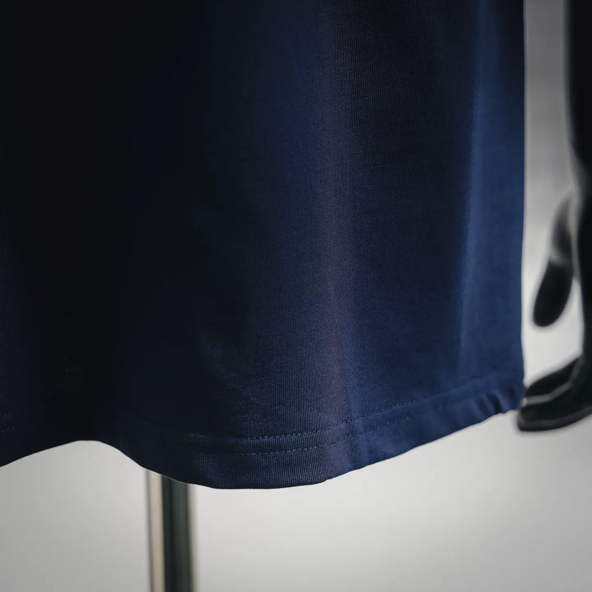 Navy blue T-shirt hem and fabric texture detail