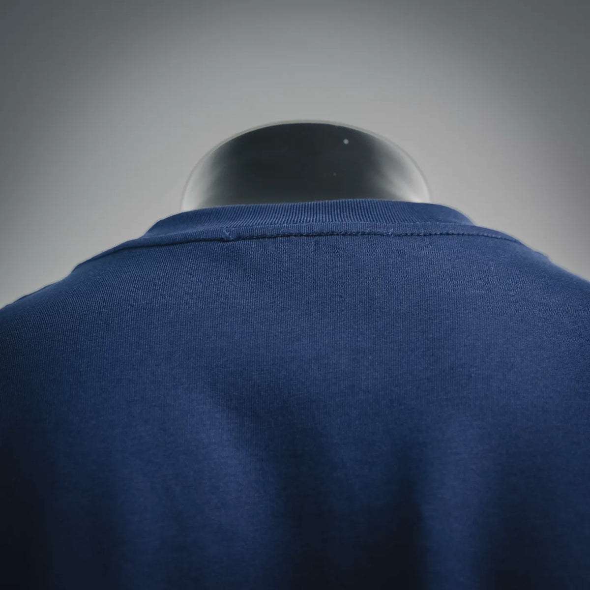 Navy blue T-shirt back collar and stitching detail