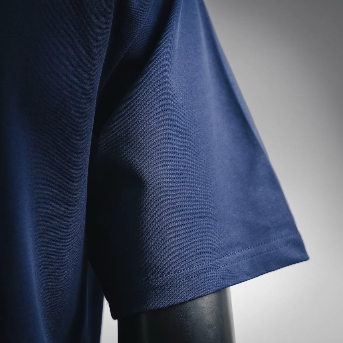 Navy blue T-shirt sleeve cuff and side seam detail