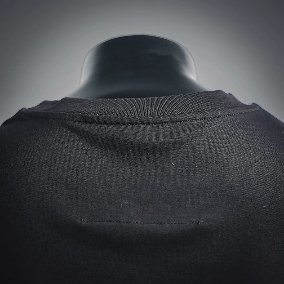 Black T-shirt crew collar detail with seam stitching