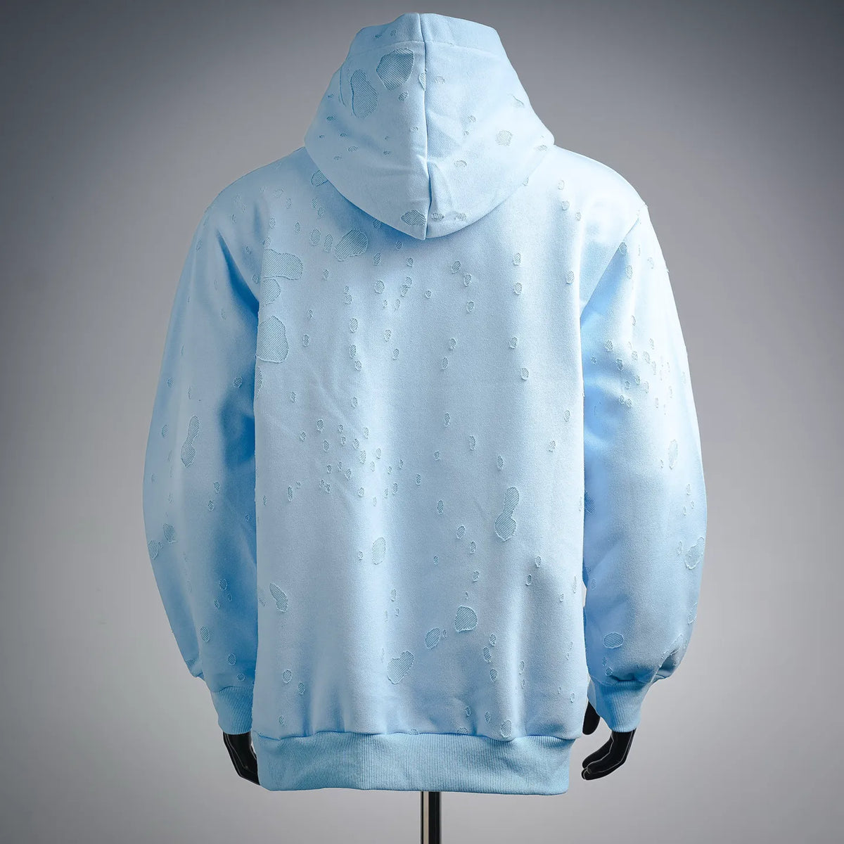 Light blue hooded sweatshirt with raised pattern and pullover kangaroo pocket
