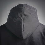 Hood close-up on black sweatshirt with textured pattern and soft hood shape