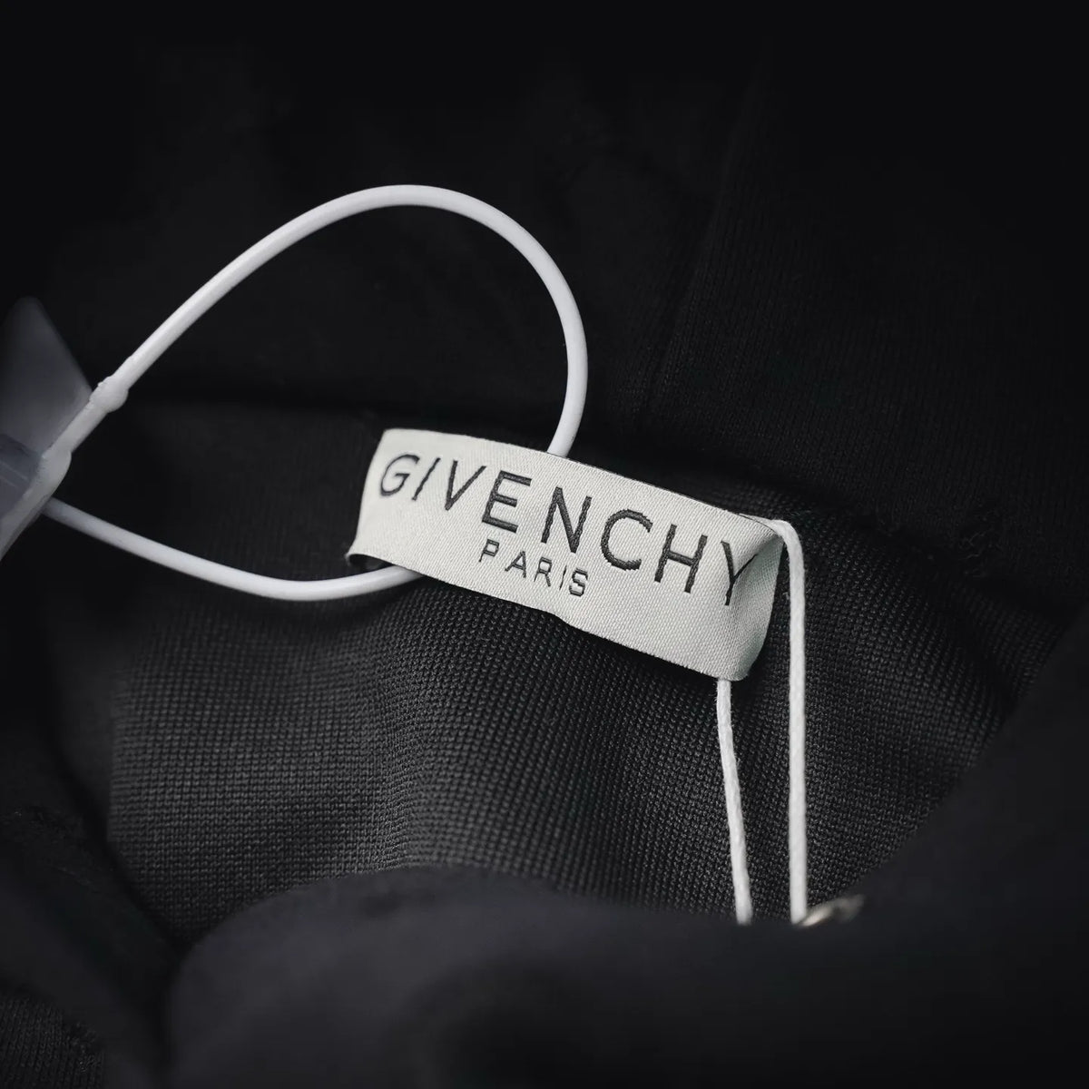Neck label on black sweatshirt with white GiveNCHY Paris branding