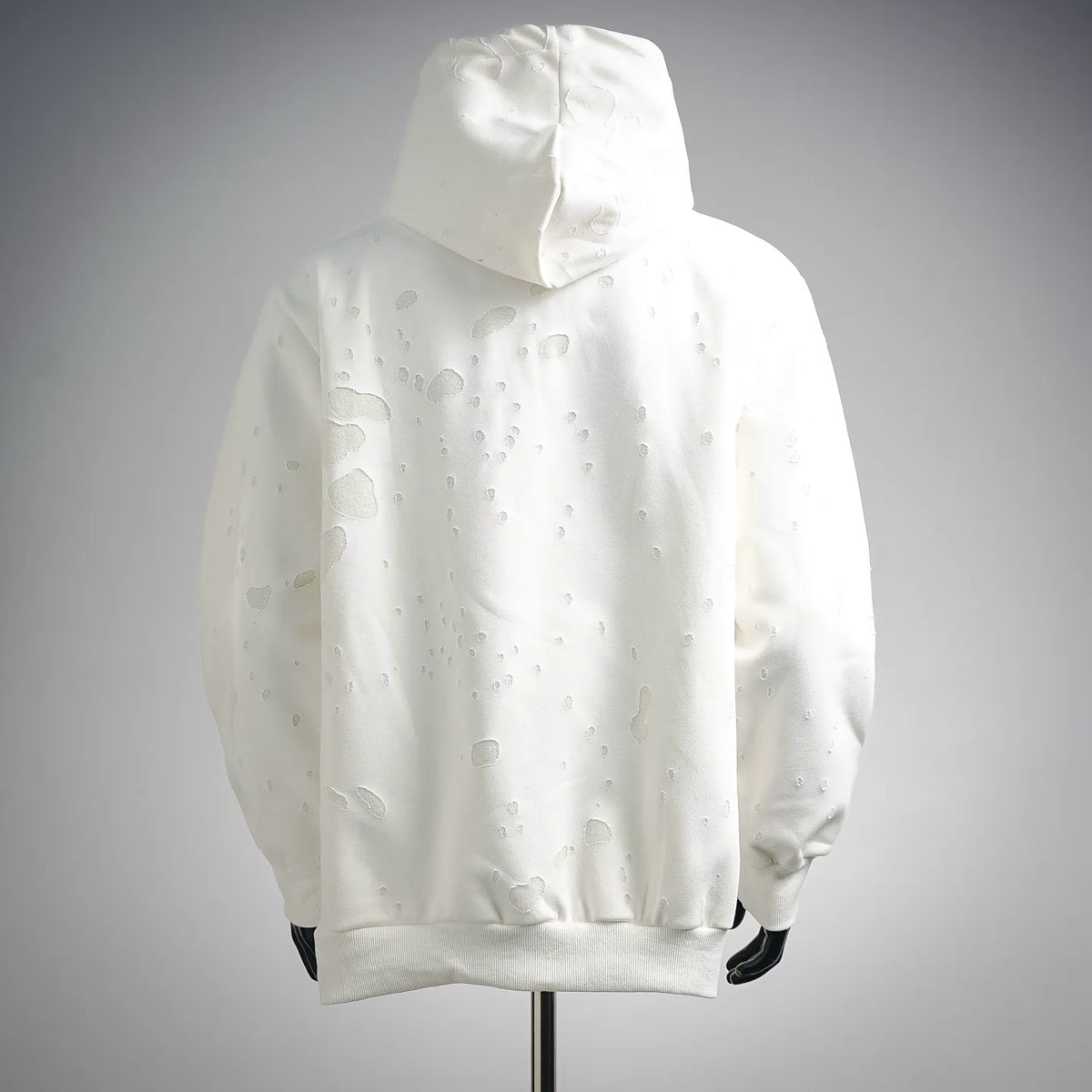 White hooded sweatshirt with textured dotted pattern, back view