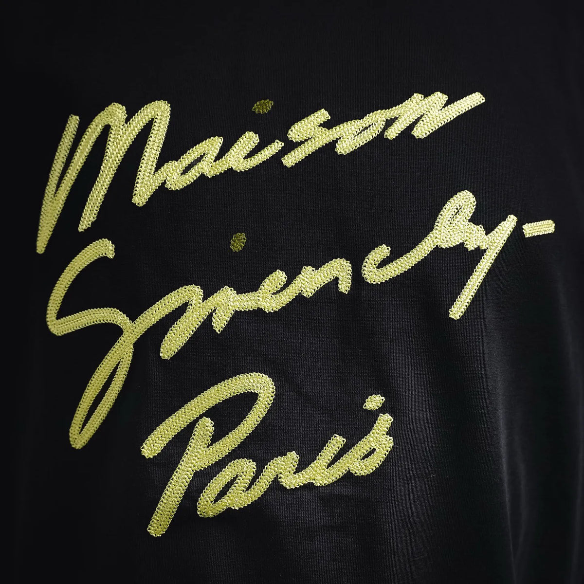 Yellow glitter script graphic on black short-sleeve T-shirt