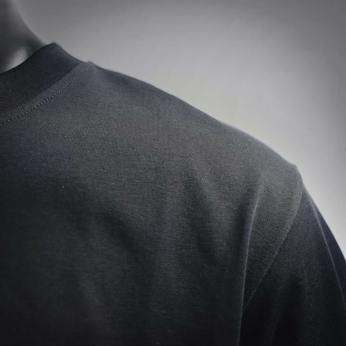Black T-shirt fabric and side panel close-up