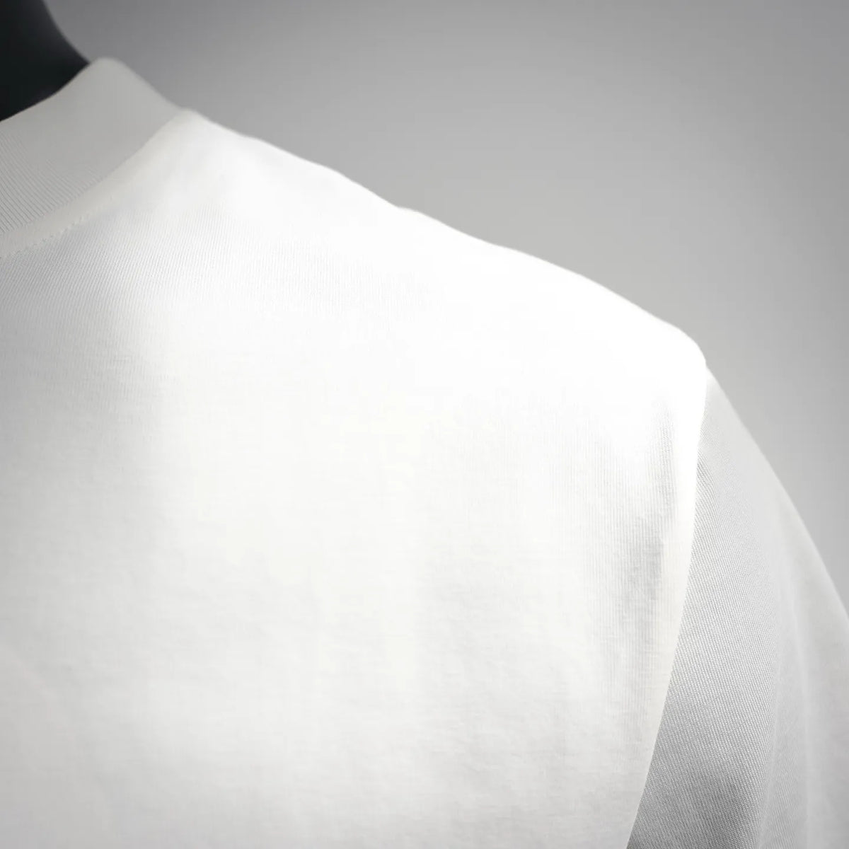 Close-up of white T-shirt fabric with smooth knit texture