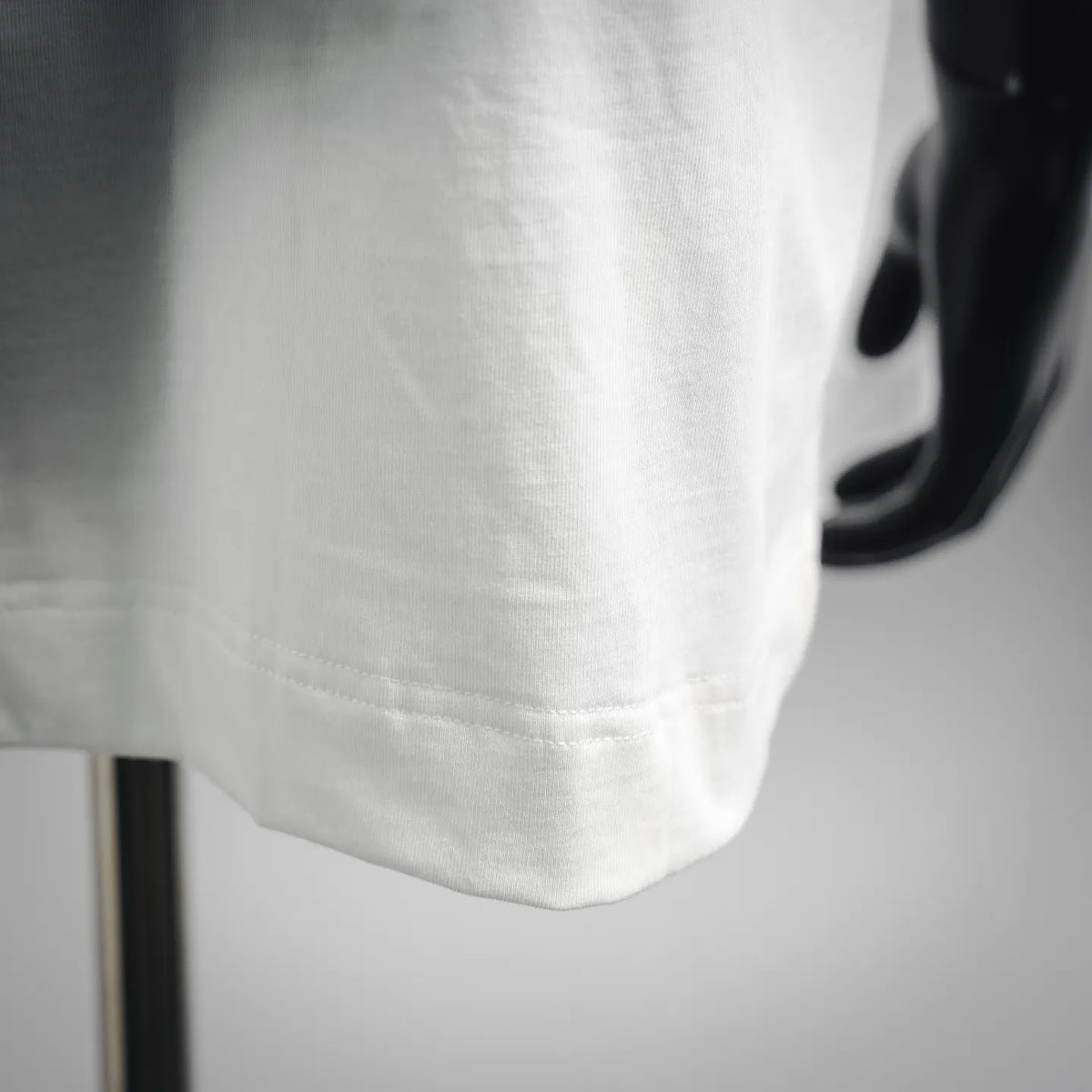 White T-shirt lower hem with stitched edge detail