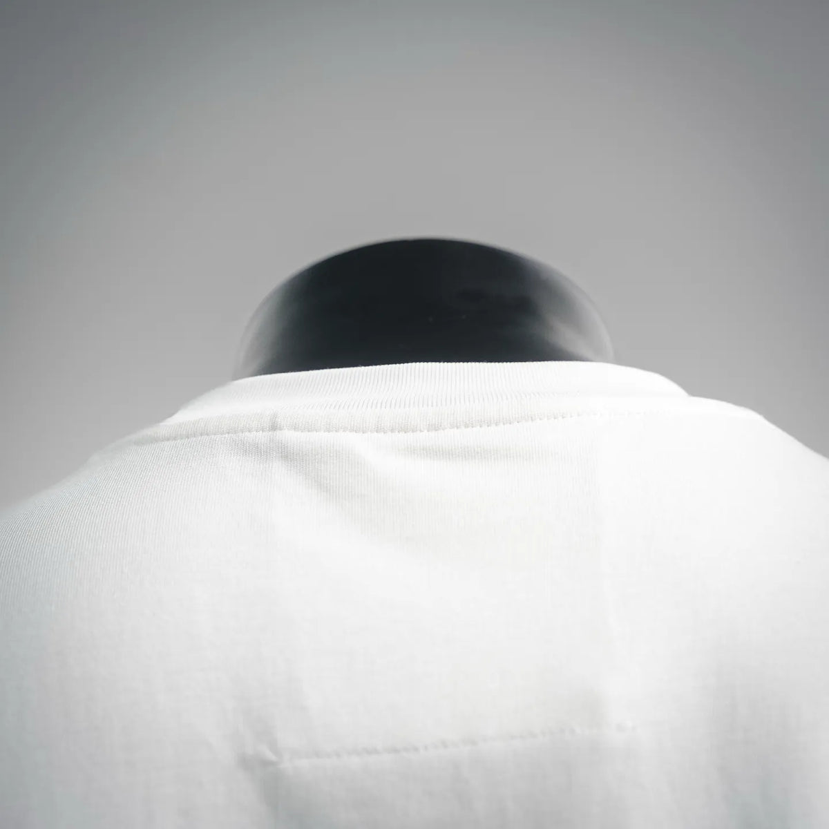 White T-shirt back yoke with stitched collar seam detail