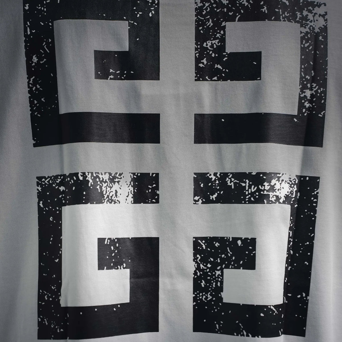 White T-shirt with black and white abstract cross graphic on back