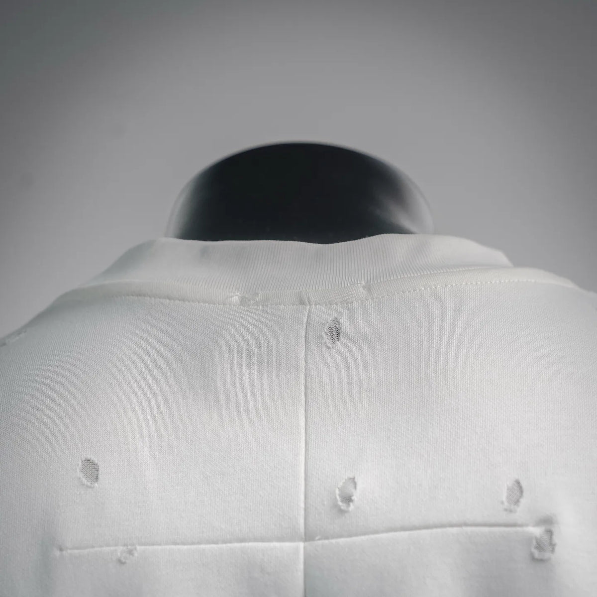 White T-shirt neckline and back yoke with distressed dot pattern