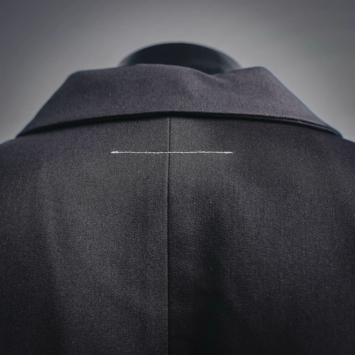 Coat shoulder and upper back seam with contrast stitch line