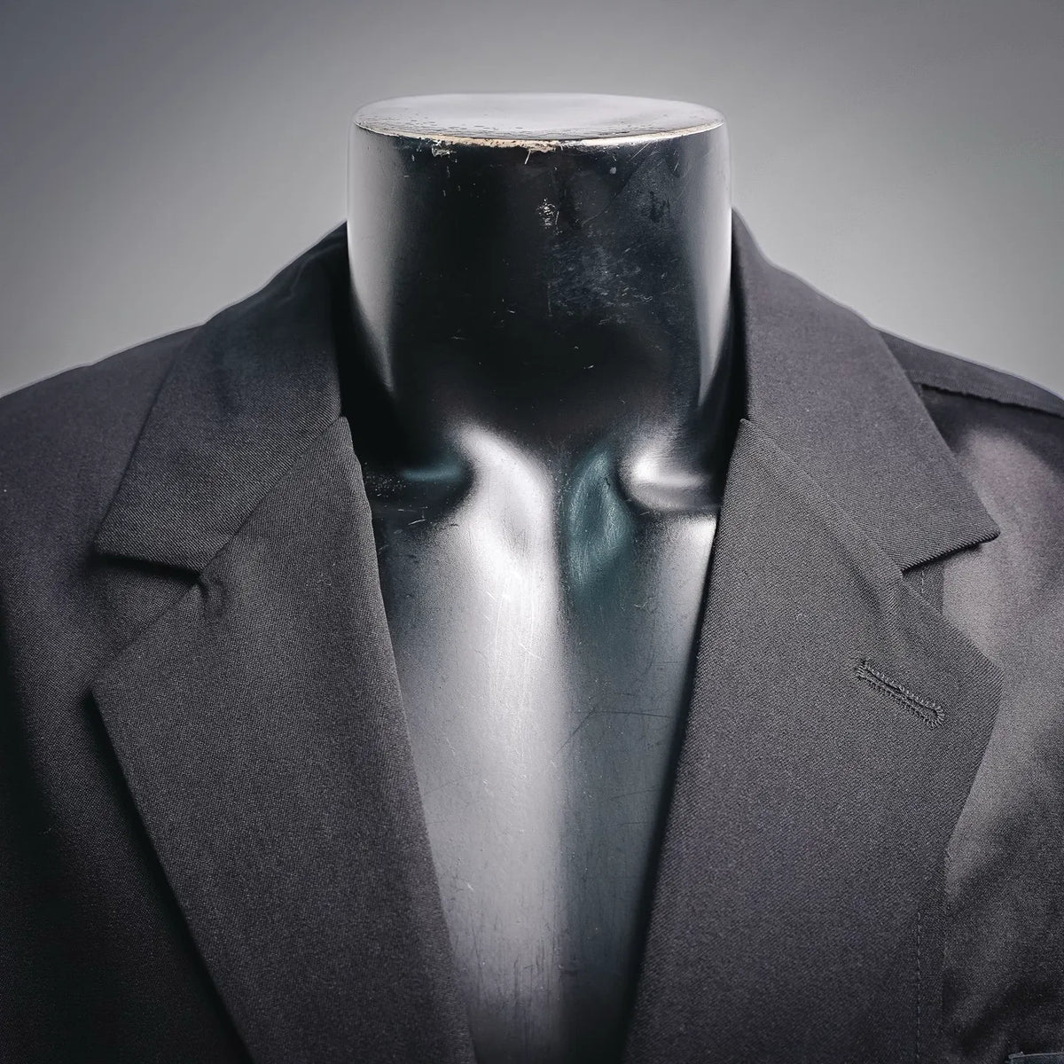 Black coat with notch lapels and collar opening on a mannequin