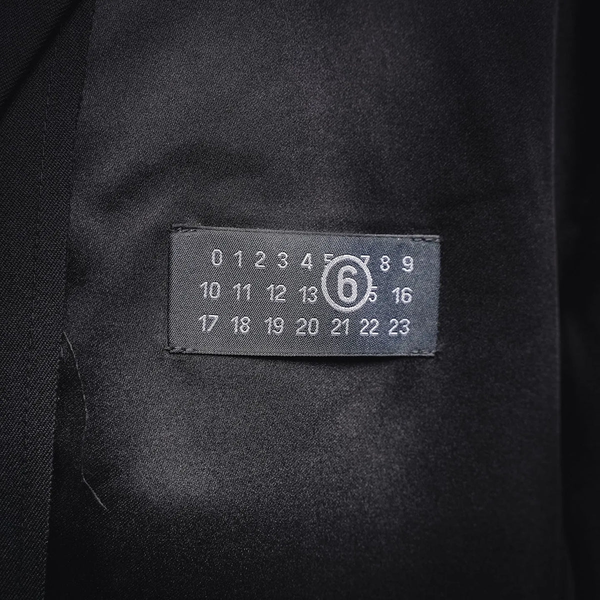 Black coat interior size label in pocket area