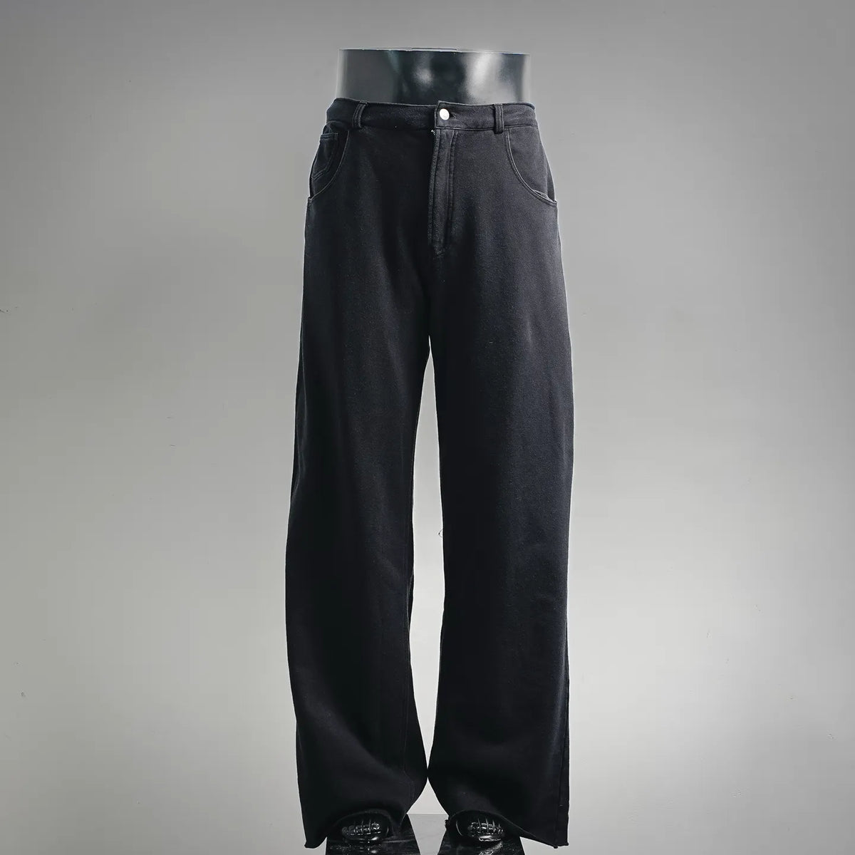 Black straight-leg pants with front button closure and belt loops