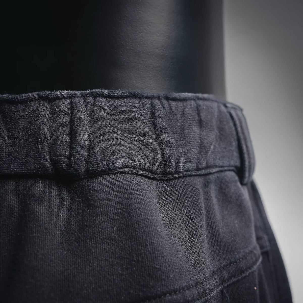 Close-up of black elastic waistband and inner waistband seam detail