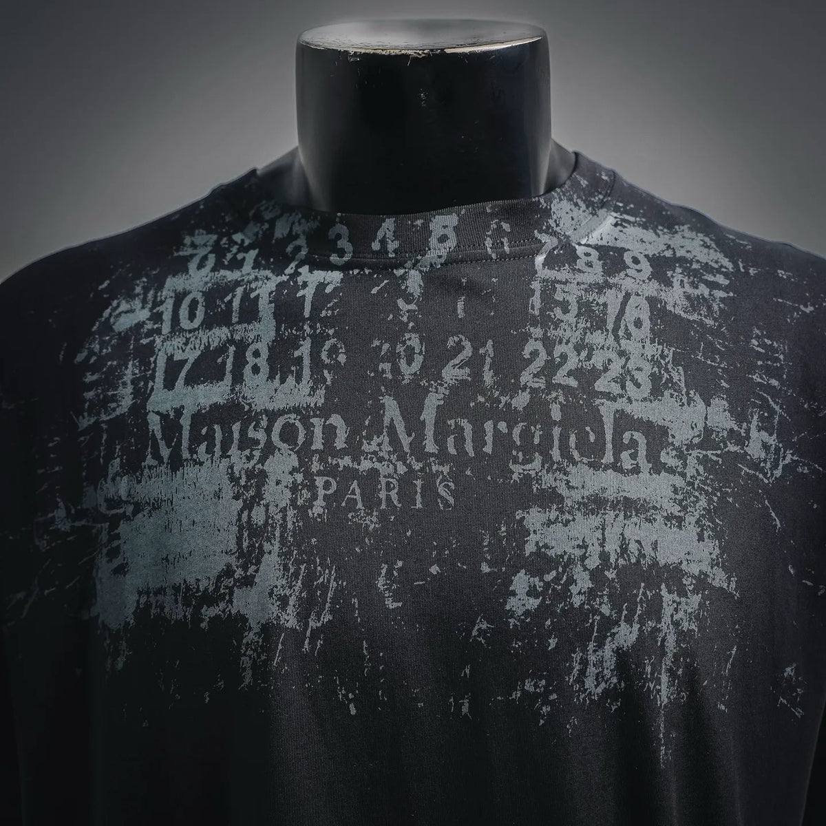 Black T-shirt close-up with distressed grey text and numbers graphic
