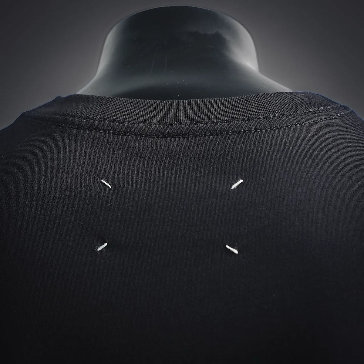 Black T-shirt back neck with small metal eyelet details