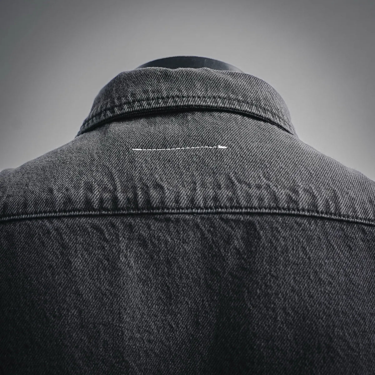 Black denim shirt back collar and yoke seam with topstitch detail