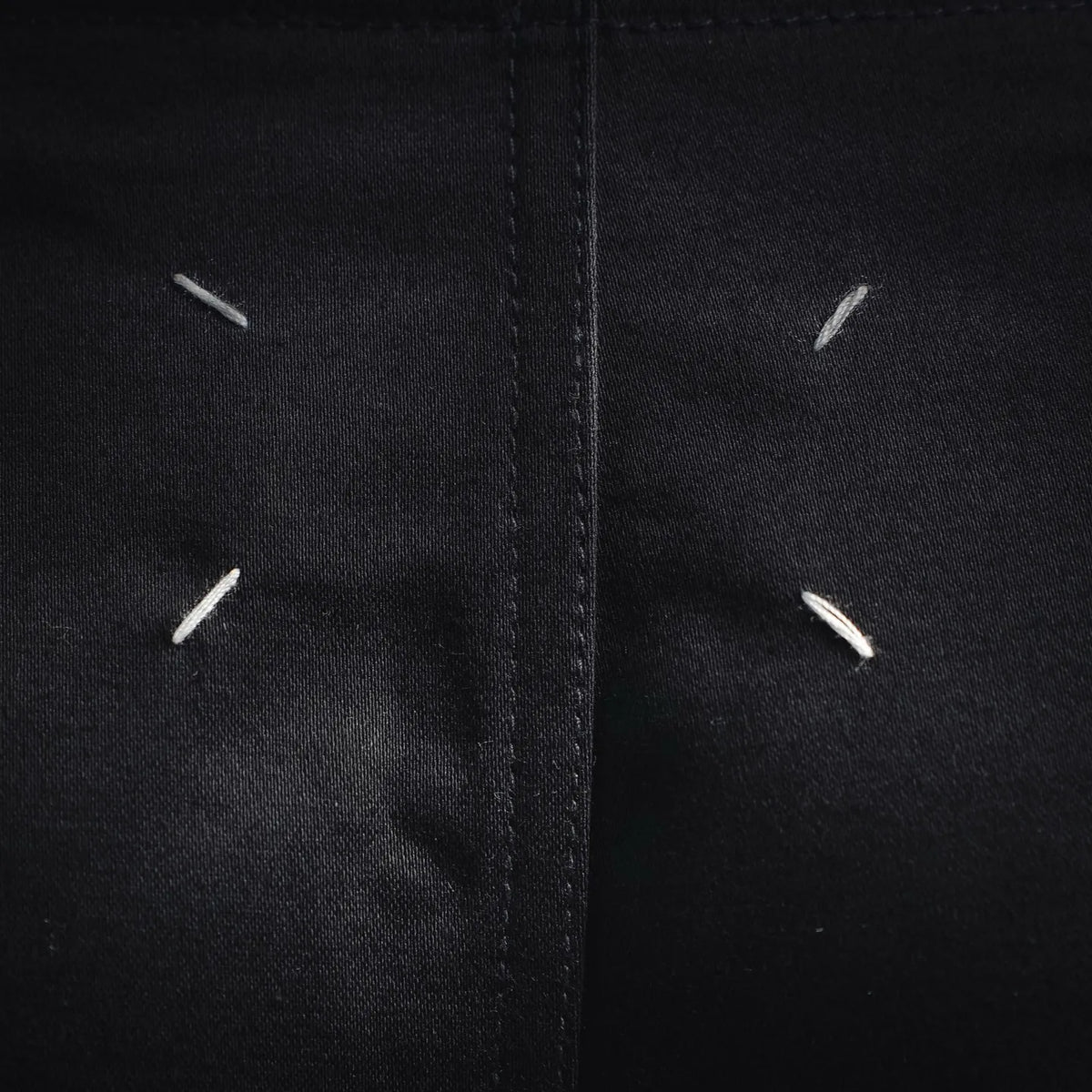 Black front fly area with decorative stitch lines.