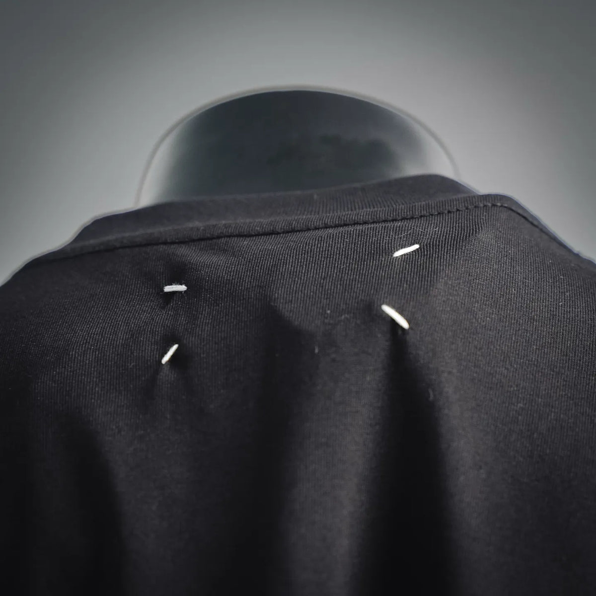 Black T-shirt back collar with small white stitch details