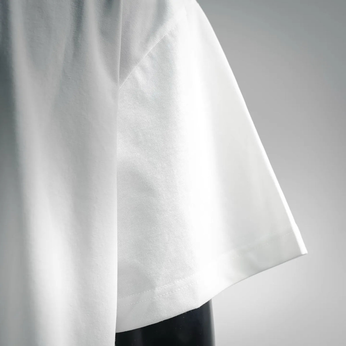 White T-shirt sleeve and side seam with clean stitched finish