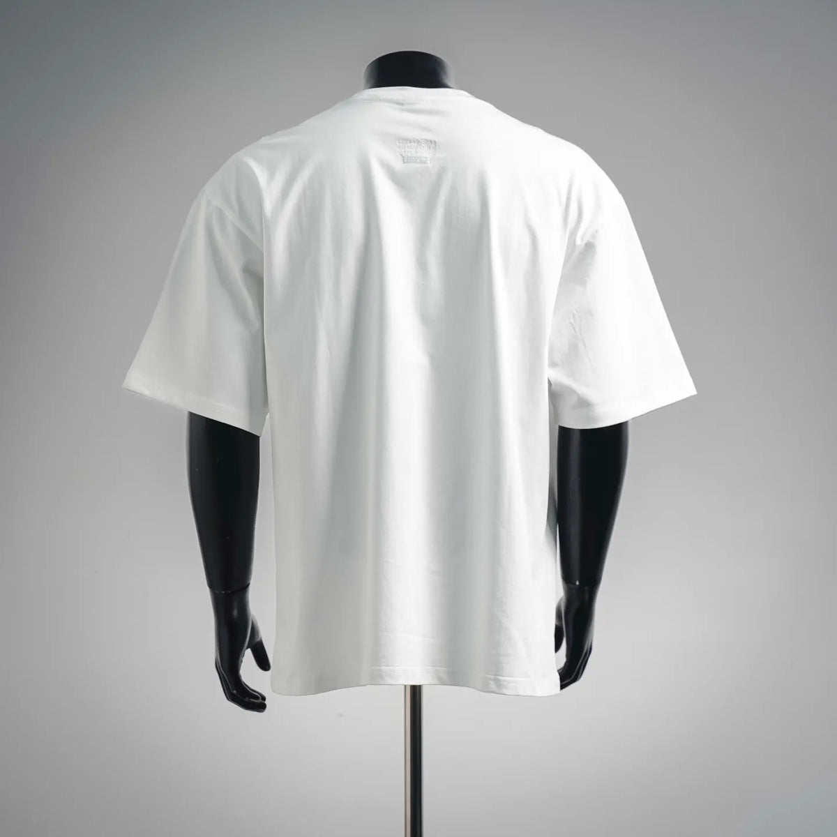 White crewneck T-shirt shown from back on a mannequin