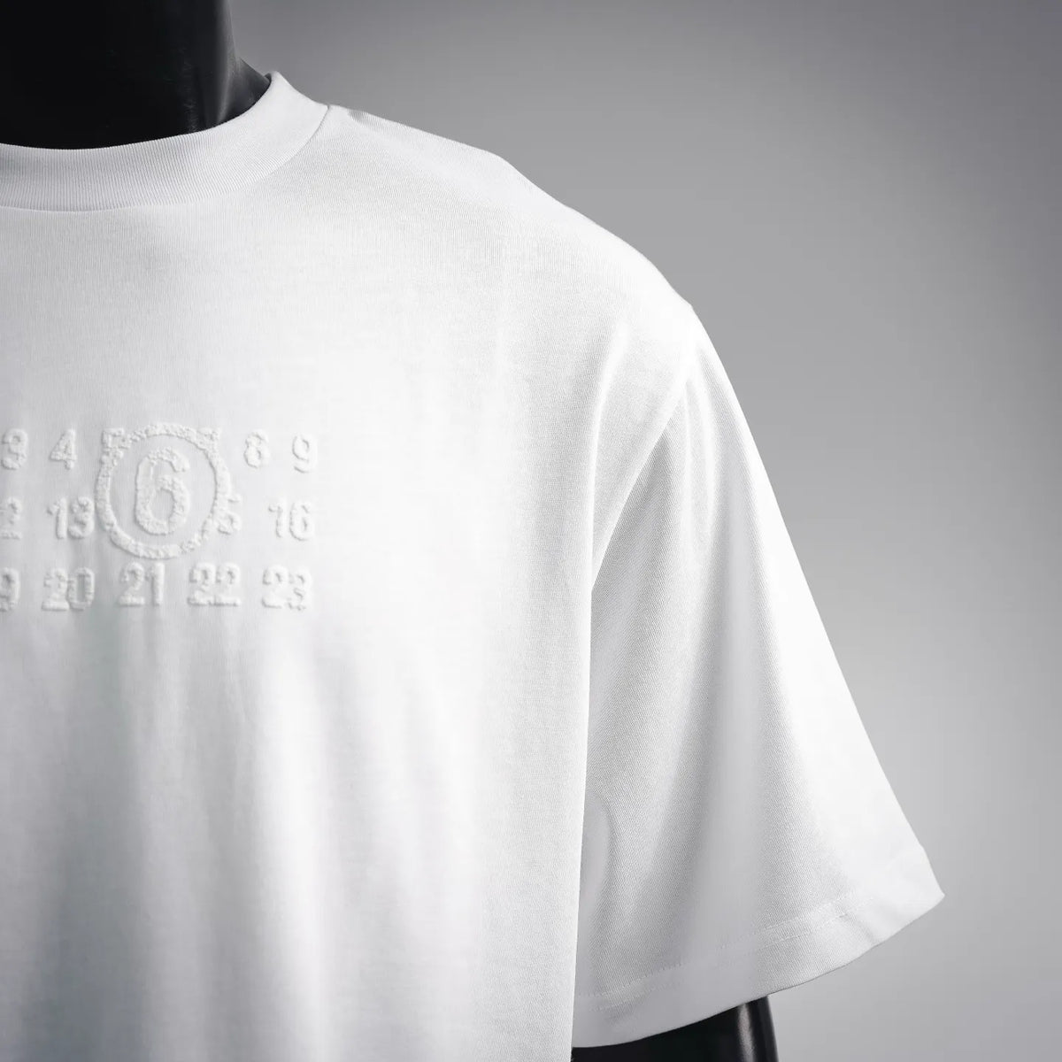 White crewneck T-shirt with numeric graphic on upper sleeve/side
