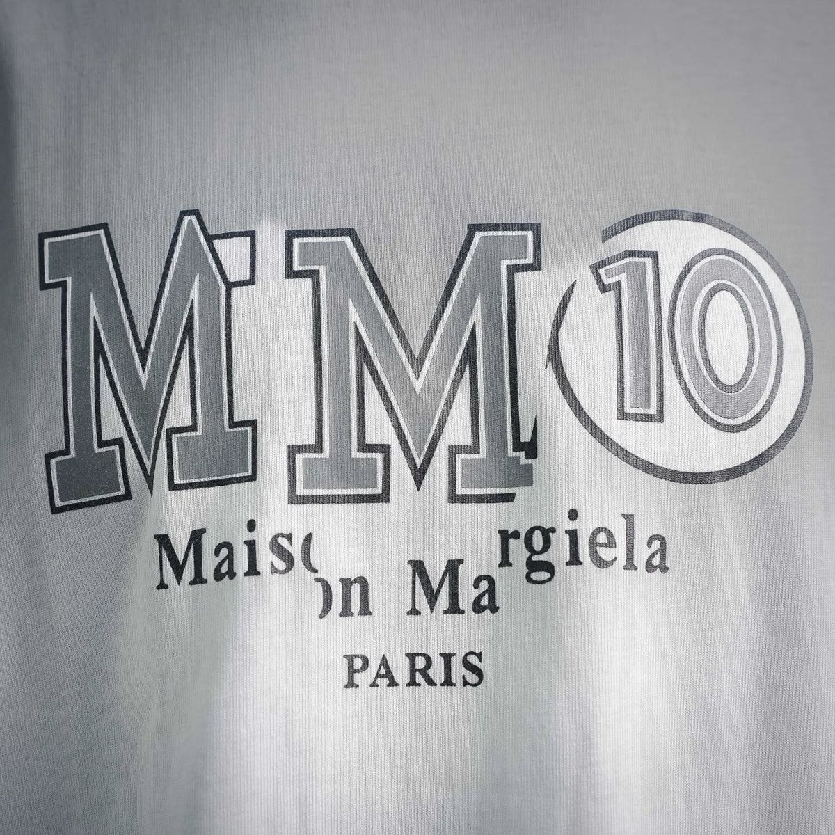 Men's white T-shirt close-up of MM10 Maison Margiela Paris graphic