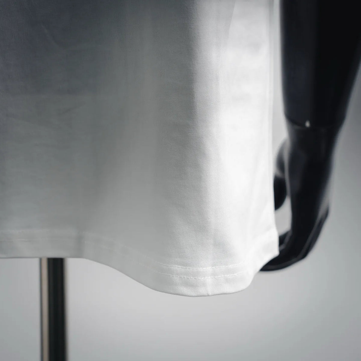 White T-shirt hem and lower front seam detail